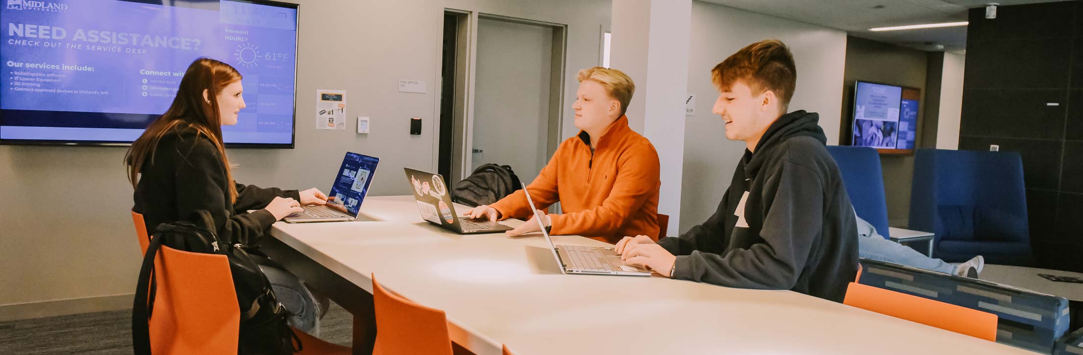 Students working on laptops in a study room